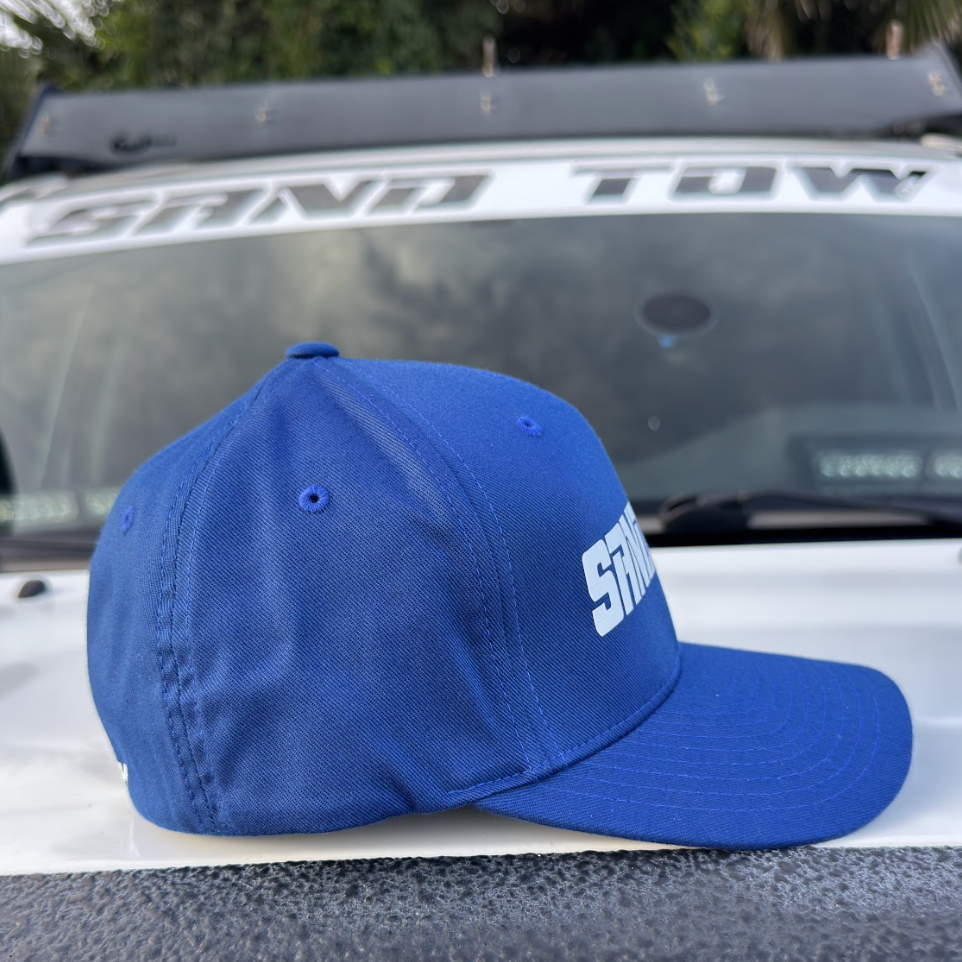 Blue cap with 'STORM' logo on a car hood