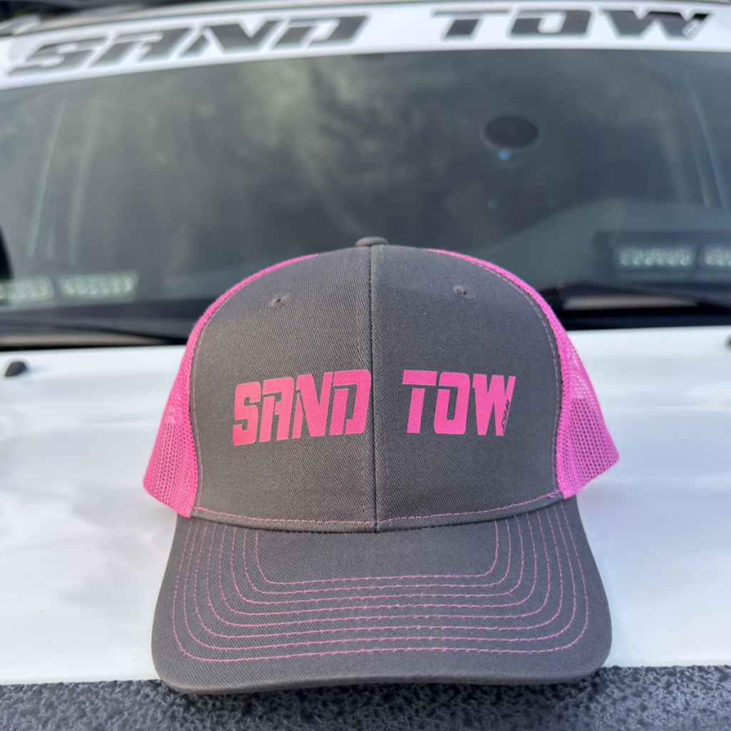 Gray cap with pink text 'SAND TOW' on a vehicle