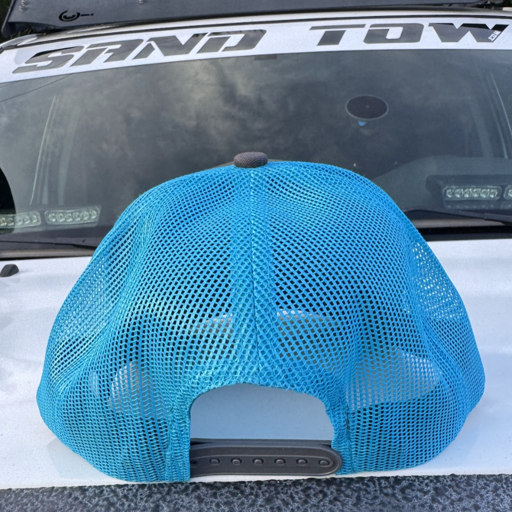 Blue mesh cap on a car's roof with 'Sway Tow' branding in the background.